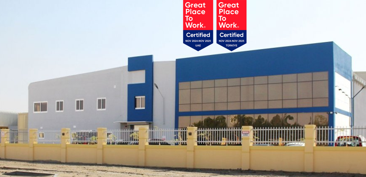 Exterior view of an ALPLA production plant in the UAE, featuring "Great Place to Work" certification badges for UAE and Türkiye, awarded in 2024, with modern industrial architecture and company branding